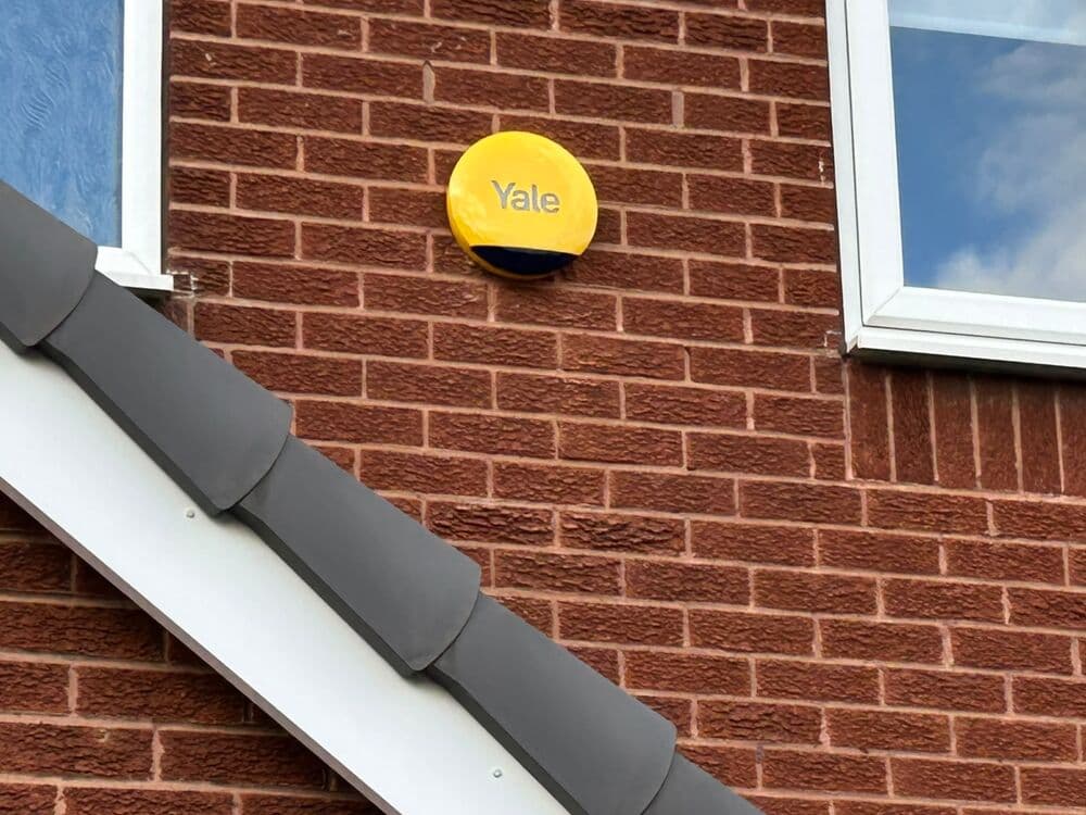 A Yale alarm sounder box fitted to a brick house wall